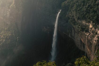 Beautiful view of Nohkalikai Falls cascading down lush cliffs in Meghalaya, India.