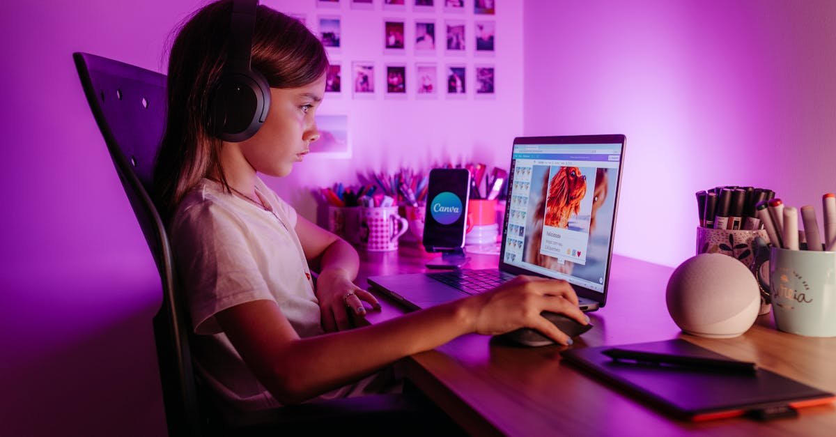 Child focused on laptop wearing headphones at desk with purple lighting. Modern tech scene.