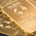 A detailed shot of gold bars labeled 'Global Intergold' as a symbol of wealth and investment.