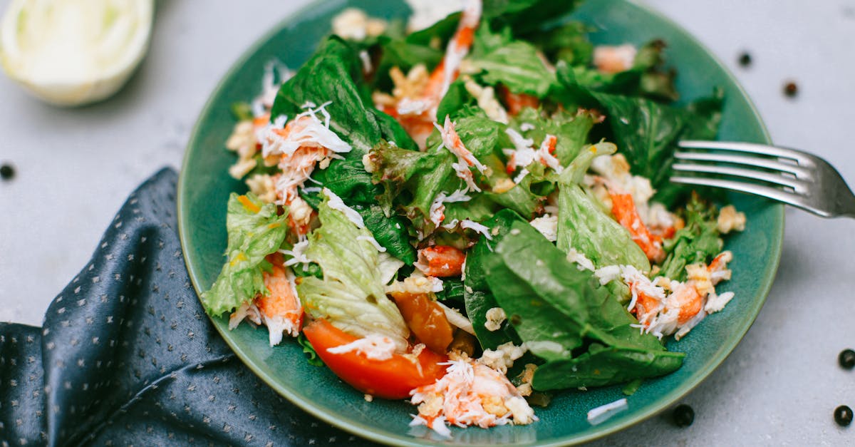 A vibrant green salad featuring mixed vegetables on a blue plate.