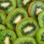 Vibrant, fresh kiwi slices arranged close-up, highlighting their juicy and nutritious appeal.