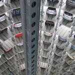 A vertical view of a spiral multi-storey car park filled with vehicles.