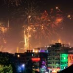 Vibrant fireworks light up the night sky during a festival in an Indian city.