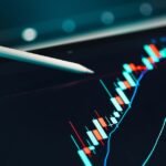 Close-up of cryptocurrency trading analysis on a digital tablet, highlighting market trends.