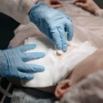 Doctors perform a medical procedure in a sterile environment, focusing on precision and care.