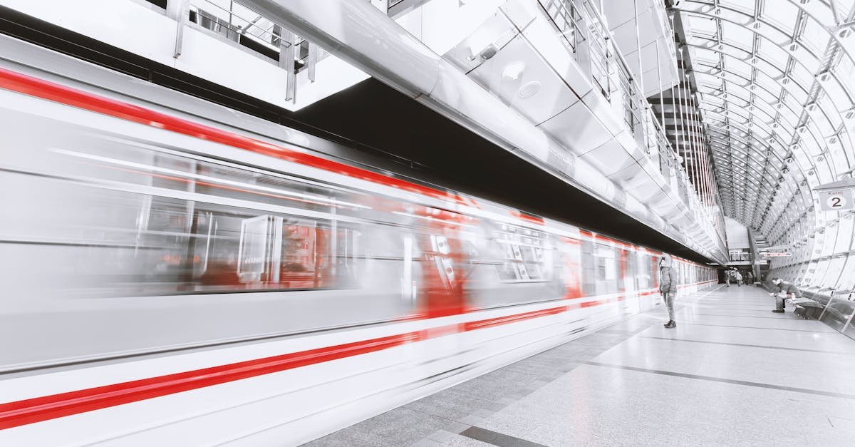 Blurred high-speed train in a sleek modern station, capturing urban commuting and motion.