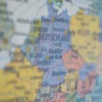 Close-up view of Germany on a colorful world map showing major cities.