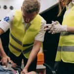 Emergency responders perform lifesaving procedures inside an ambulance.