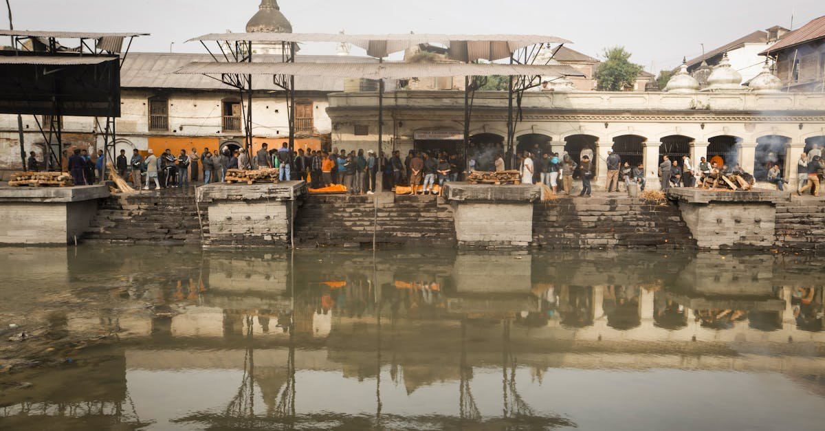 A serene capture of a traditional ceremony taking place by the river in Kathmandu, Nepal.