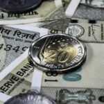 Detailed view of Indian rupee banknotes and coins, showcasing currency and finance concepts.
