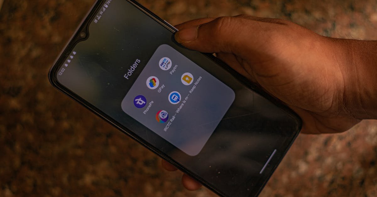 A hand holds a smartphone displaying popular payment apps for digital transactions.