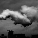 Black and white image of factory emissions illustrating industrial pollution.