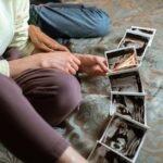Expectant parents sit on a bed sharing ultrasound photos, symbolizing family love and anticipation.