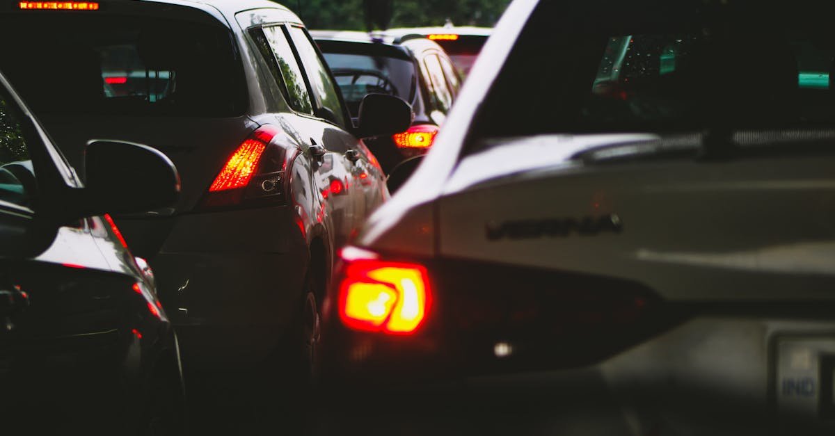 A close-up view of a traffic jam showcasing rear car lights glowing at dusk.