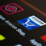 Close-up of the Amazon shopping app icon on a smartphone screen. Ideal for online shopping and technology themes.